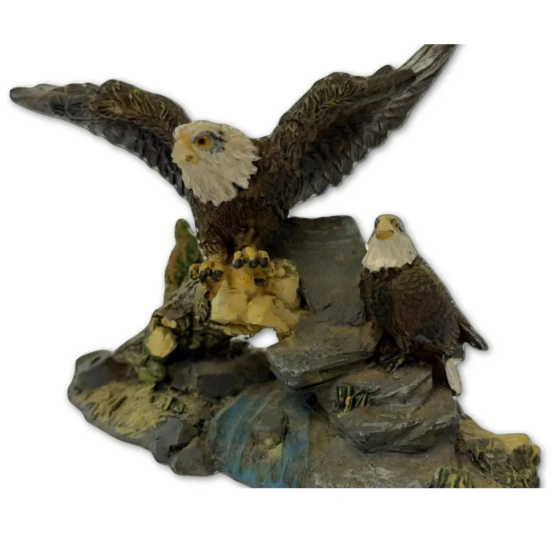 Sculpture features two bald eagles perched on a rock and branch formation Coin Hub