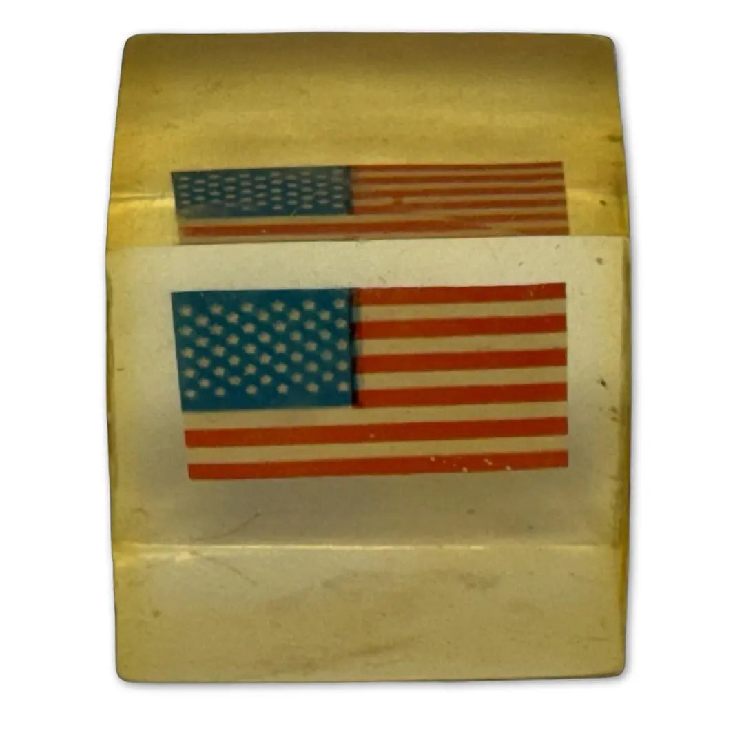 Vintage Lucite, acrylic, or resin paperweight with a US American flag embedded inside. Heritage Pastime