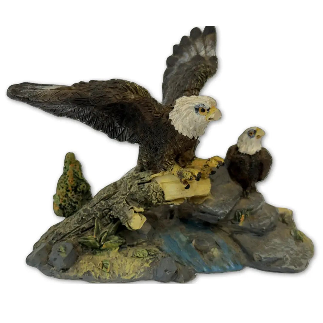 Sculpture features two bald eagles perched on a rock and branch formation Coin Hub