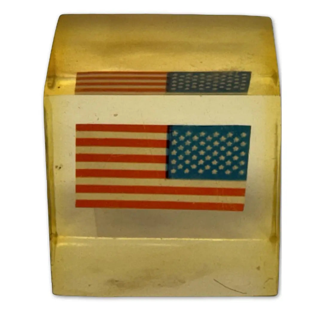 Vintage Lucite, acrylic, or resin paperweight with a US American flag embedded inside. Coin Hub